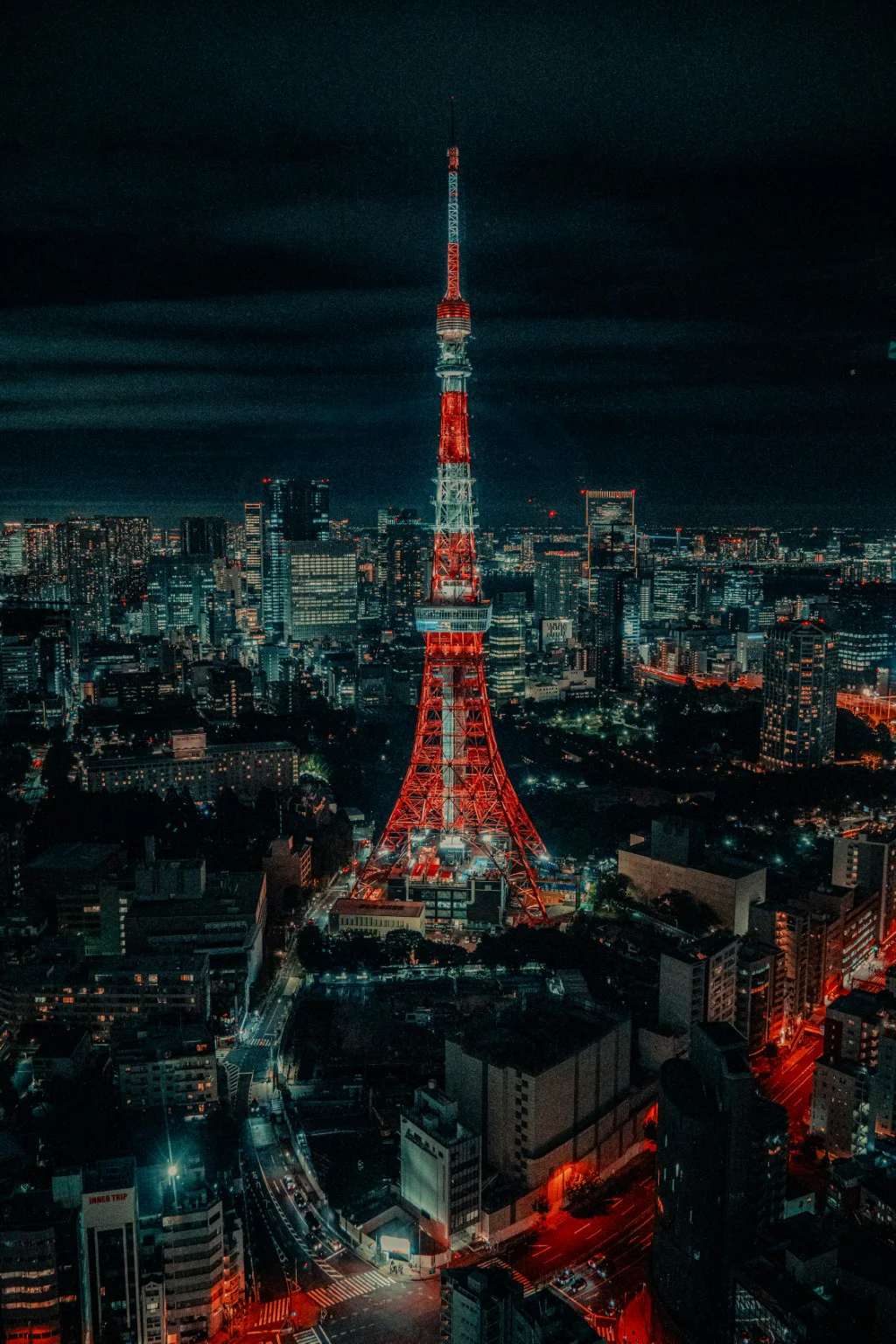 Tokyo Tower glowing red over the city at night
